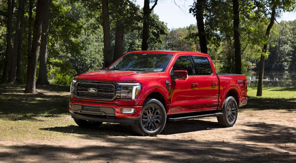 A red 2025 Ford F-150 from the front at an angle after leaving a Ford dealer.