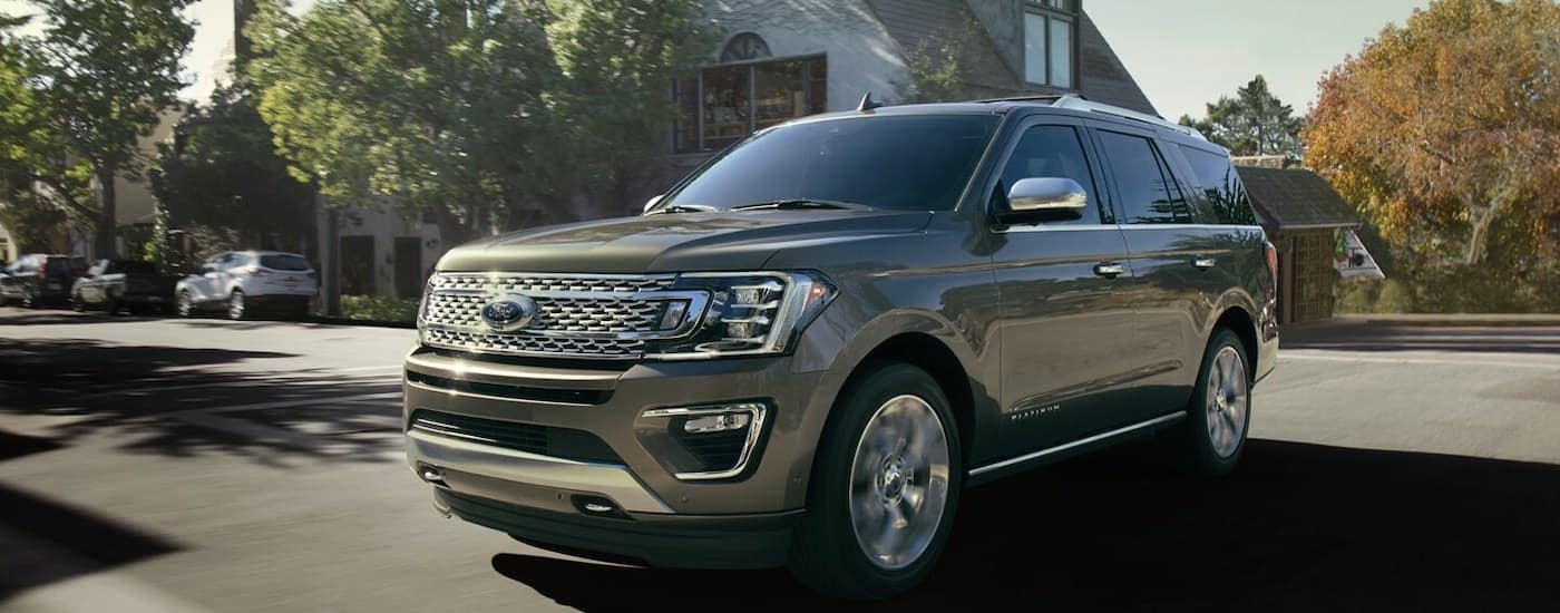Grey 2020 Ford Expedition driving down a neighborhood street.