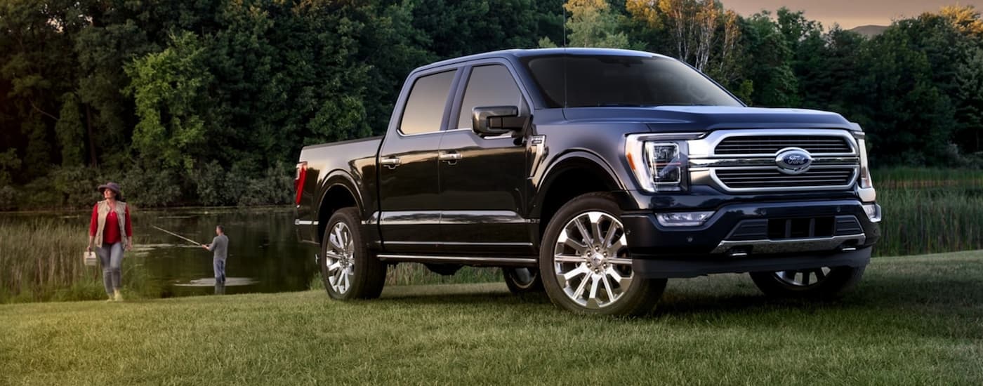 Blue 2021 Ford F-150 parked alongside a river