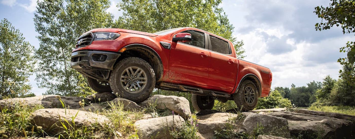 Red 2021 Ford Ranger parked off-road on a hill.