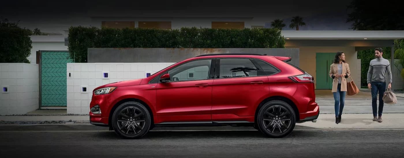 A red 2024 Ford Edge parked in a city.