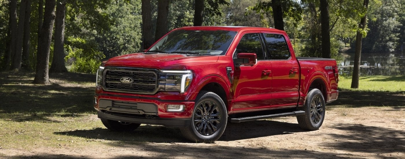Red 2024 Ford F-150 parked next to a lake