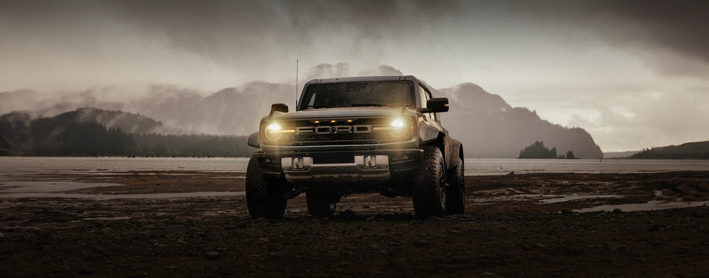 Brown 2026 Ford Bronco driving off-road.