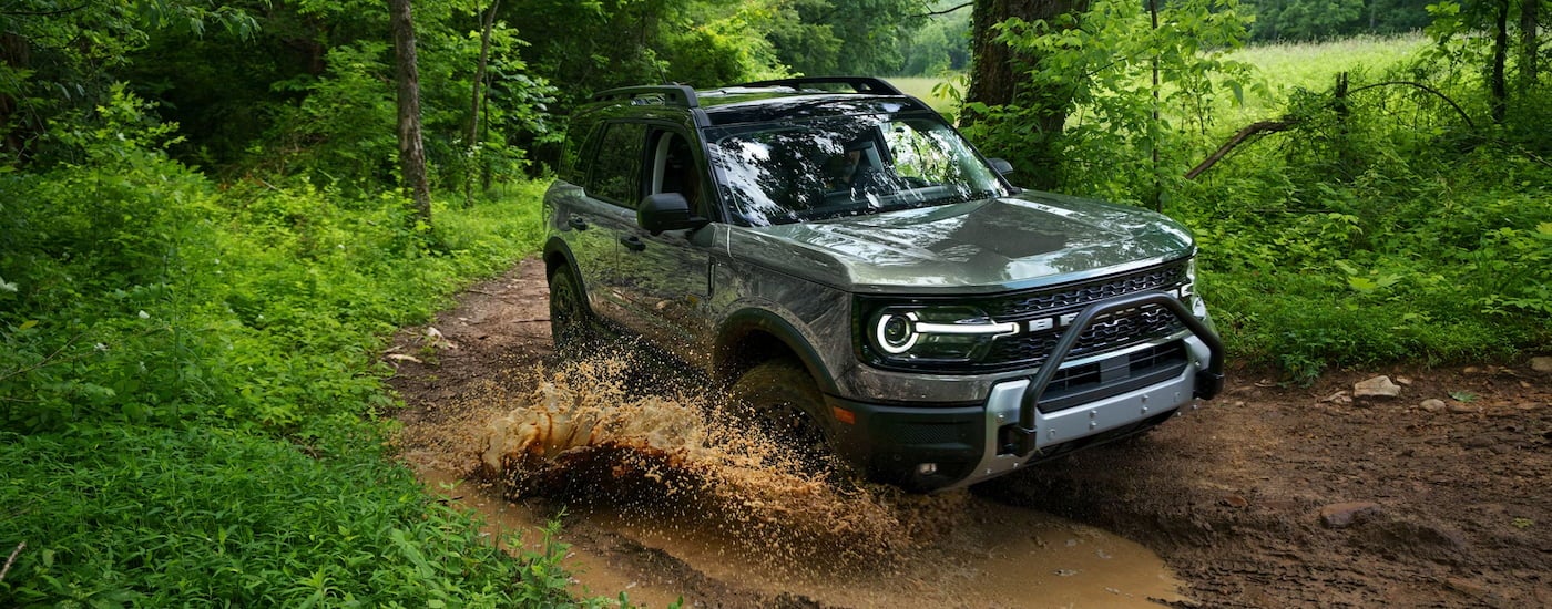 Grey 2026 Ford Bronco Sport driving off-road.