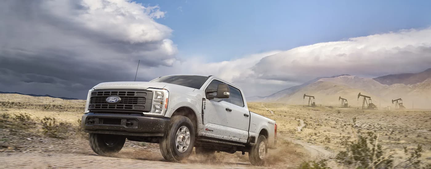 White 2026 Ford F-250 parked off-road on a hill.