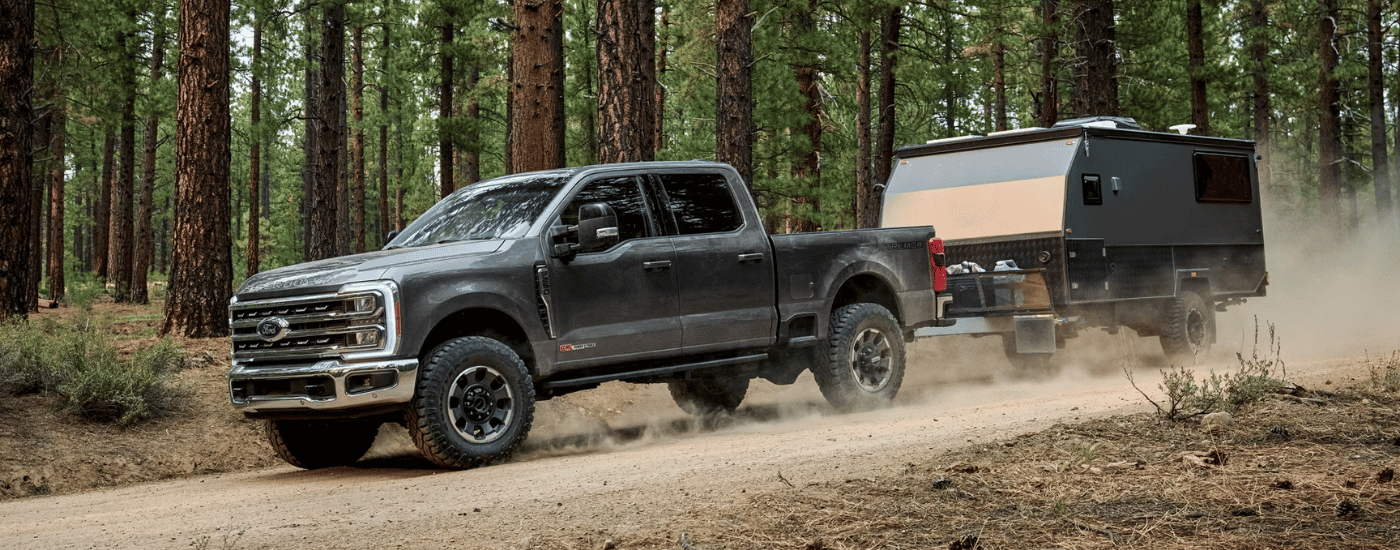 Black 2026 Ford F-250 SD Tremor towing a camper