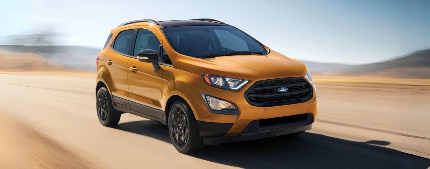 A yellow 2021 Ford EcoSport driving.