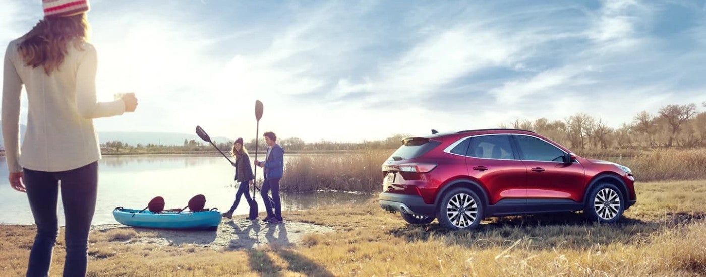 A red 2022 Ford Escape near a lake.
