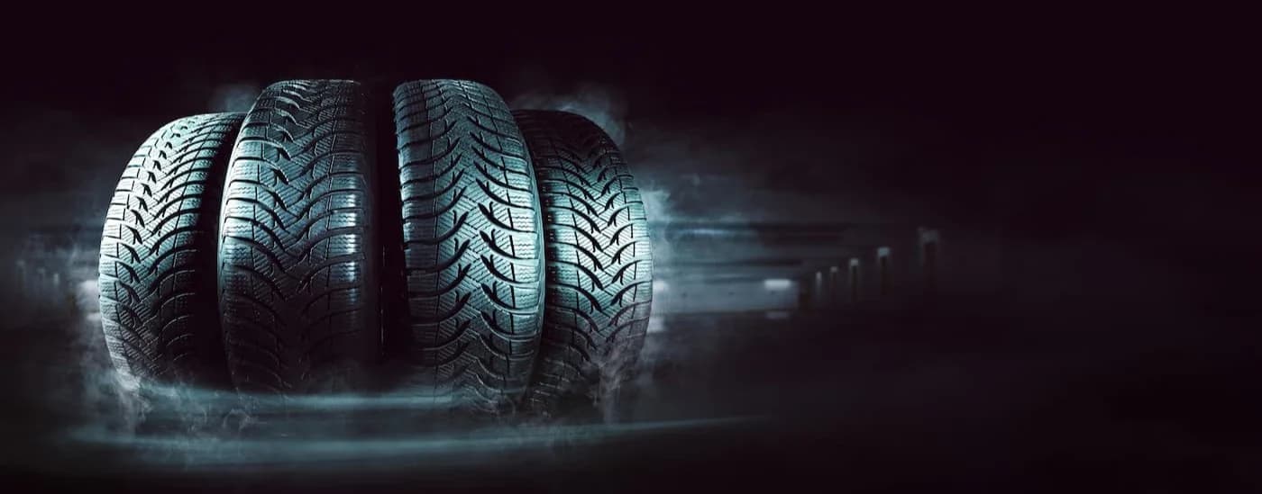 Row of tires on a black background.
