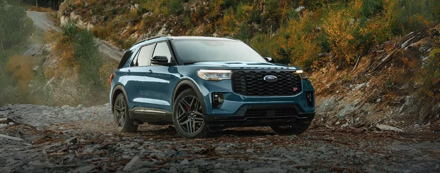 A blue 2025 Ford Explorer ST parked off-road