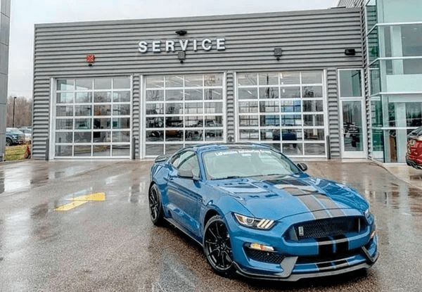 image of a Ford Mustang in front of La LaFontaine Ford Birch Run Service garages